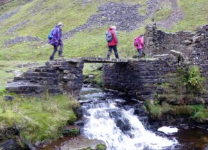 Crossing the slab bridge over Gunnerside Beck by Blakethwaite Lead Mines